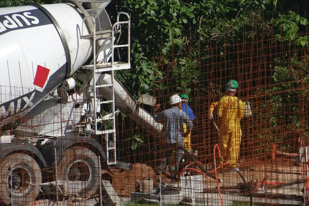 Concrete truck pour with workers